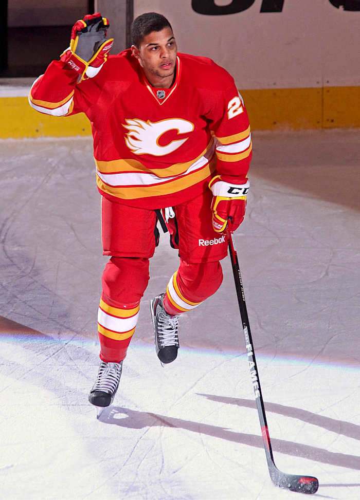 UNKIND CUT Aliu had two goals and an assist in his first two games for Calgary—but had to play without his Afro, which he shaved off to avoid standing out.